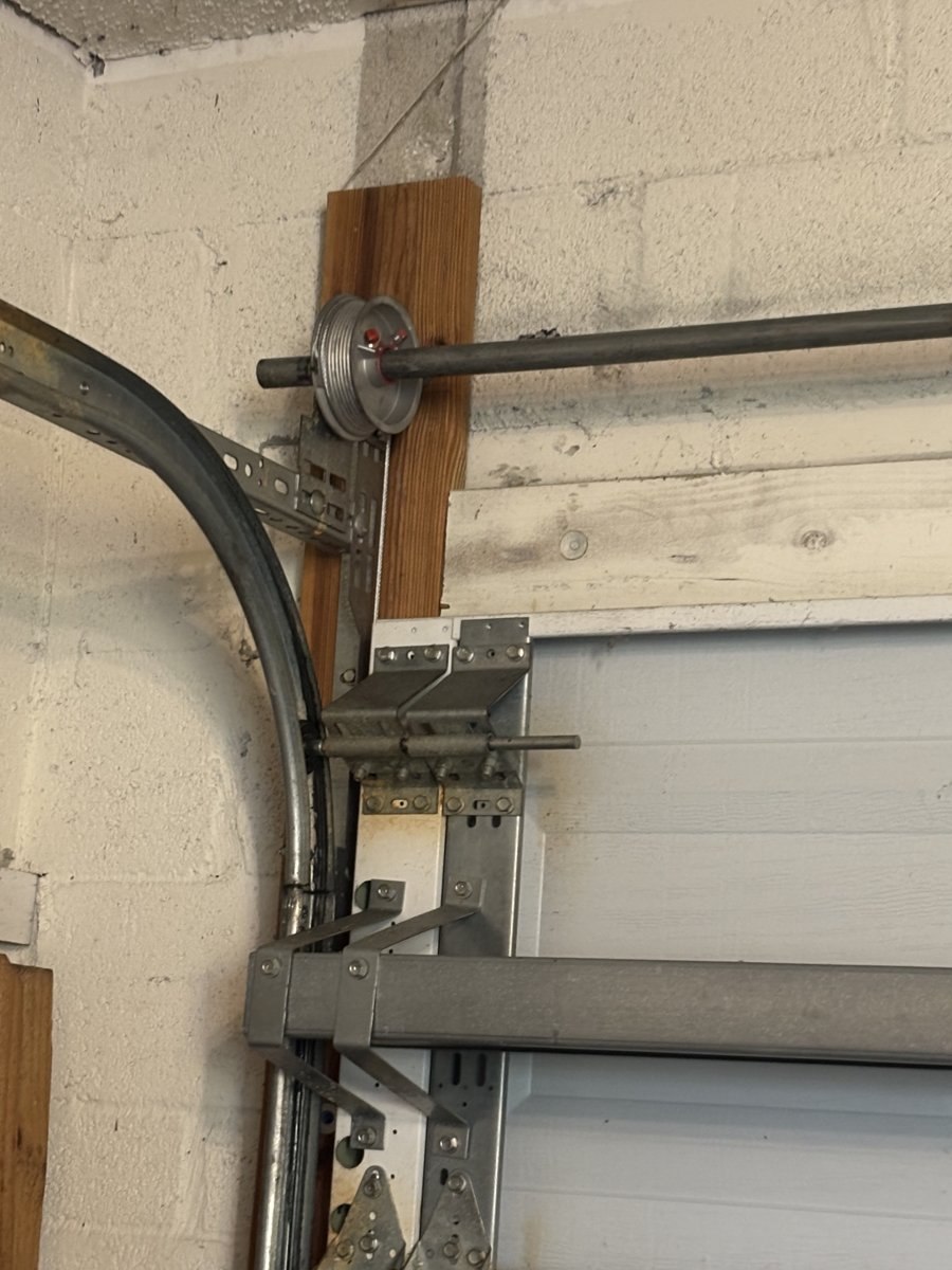 Garage door cable and safety retainer bracket serviced