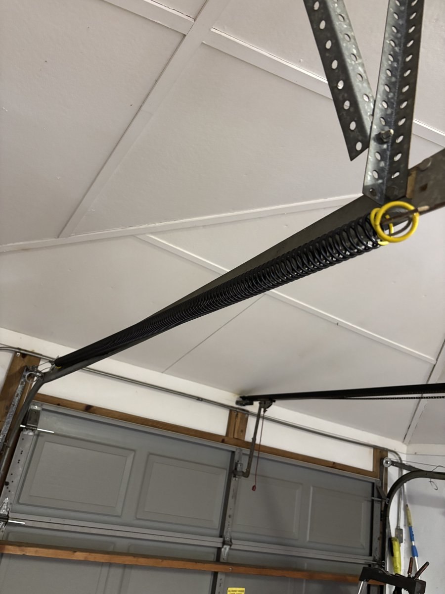 Extension spring serviced along the door track in South Florida