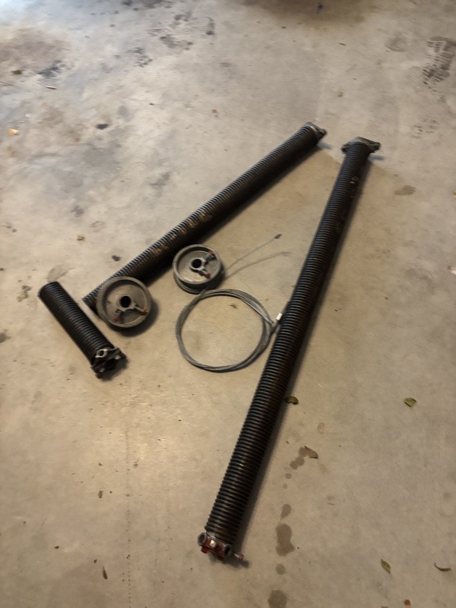 Replacement garage door springs and cable drums staged in Boca Raton, FL