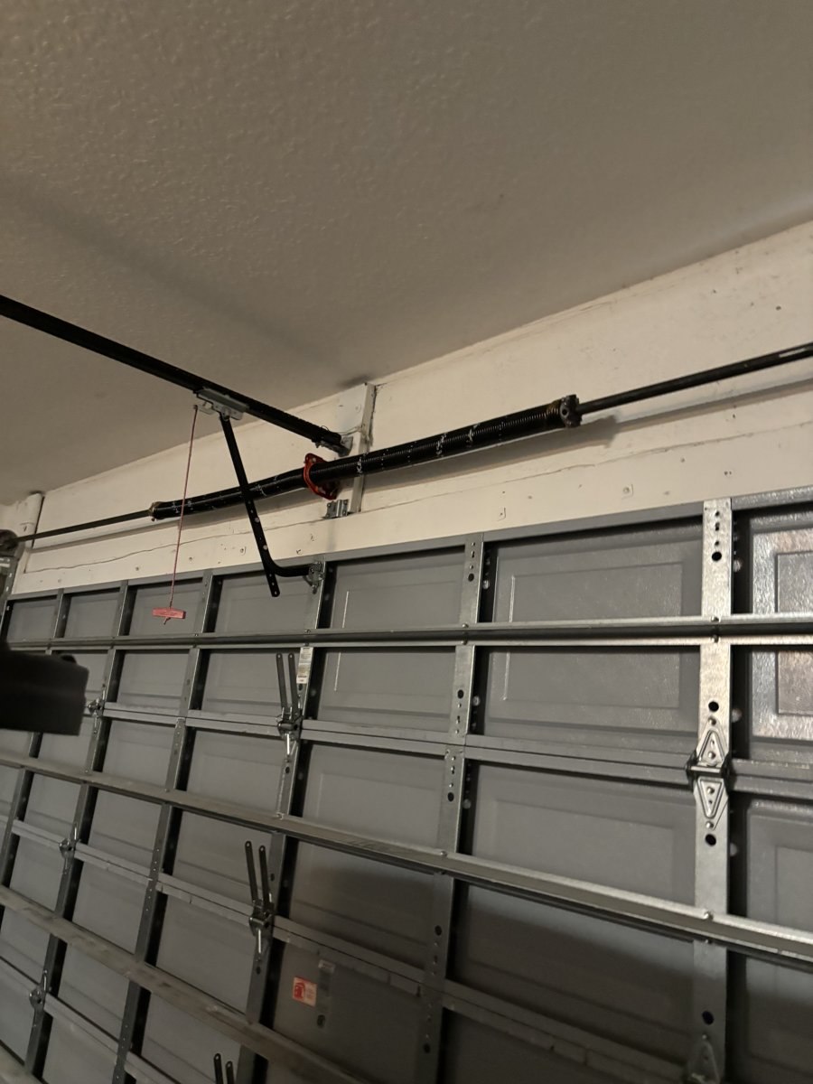 Garage door torsion spring and center strut bracket serviced