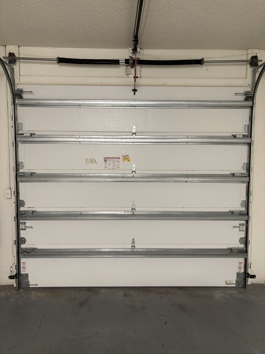 Close-up of a garage door torsion spring assembly repaired in West Palm Beach, FL